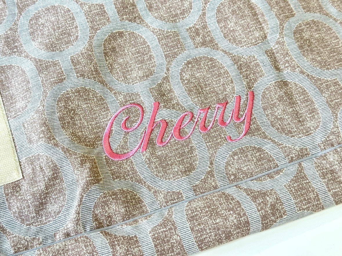 Optional pink script name embroidery example on Elmo Aqua Gray cover